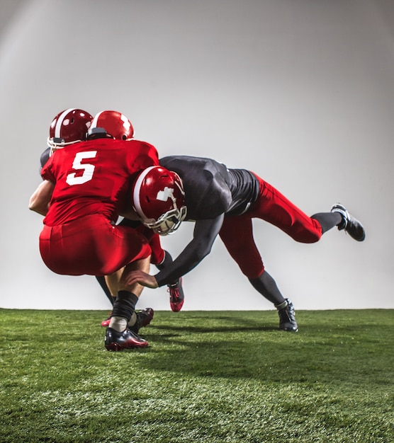 The three american football players in action