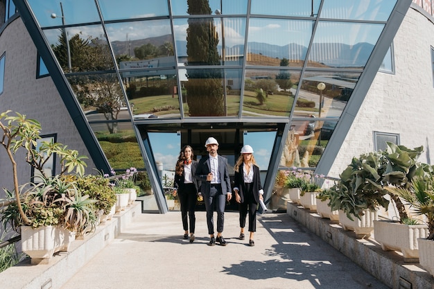 Three architects in front of modern building