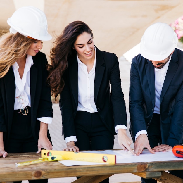 Three architects with plan