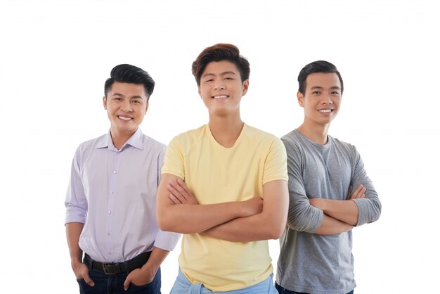 Three Asian male friends standing and smiling