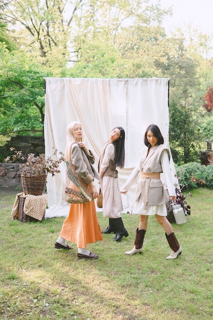 Three beautiful women standing in garden .