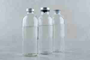 Free photo three bottles of medical ethanol on gray background. high quality photo