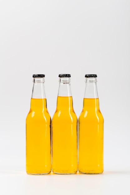 Three bottles with beer on table