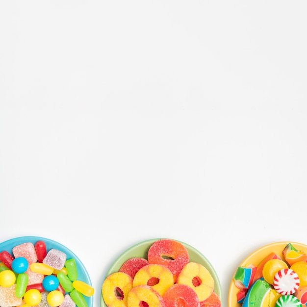 Three bowl on table with sweetmeats and jelly fruits 