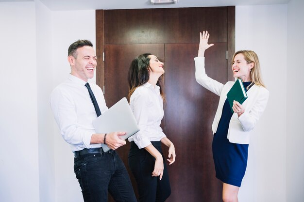 Three business people celebrating