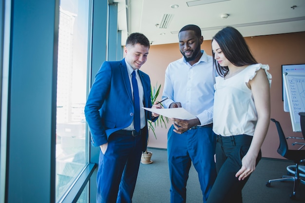 Three business people with documente