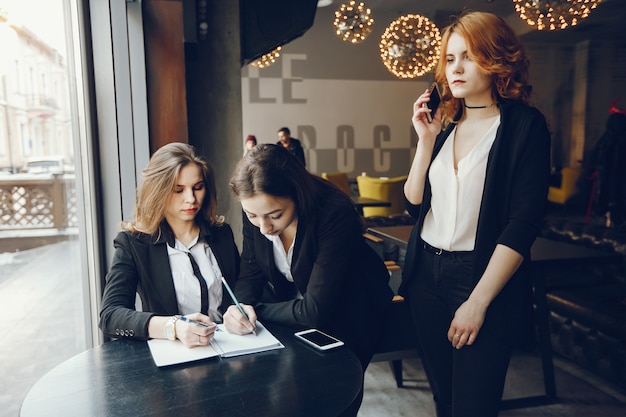 three businesswomen in a cafe