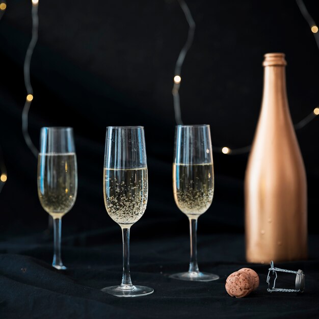 Three champagne glasses on table