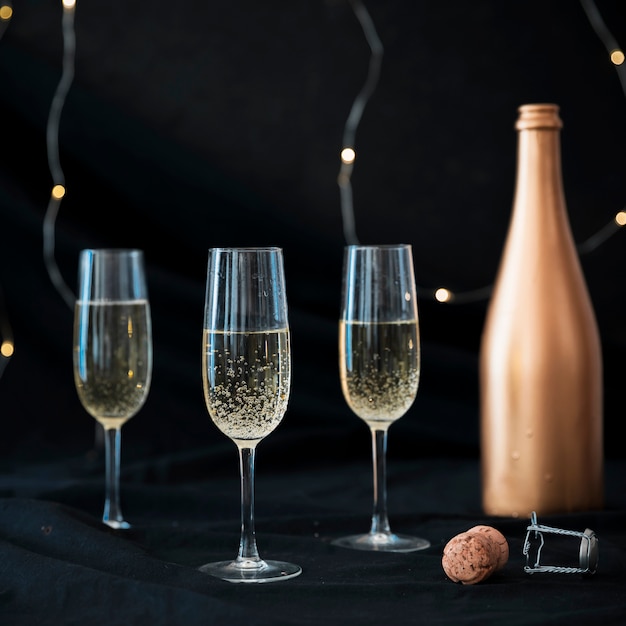 Three champagne glasses on table