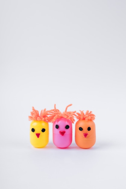 Three chickens made of egg toy boxes on table