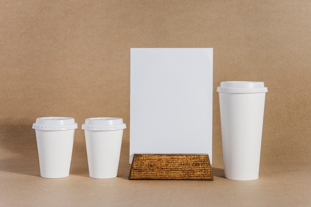 Three coffee cups next to board