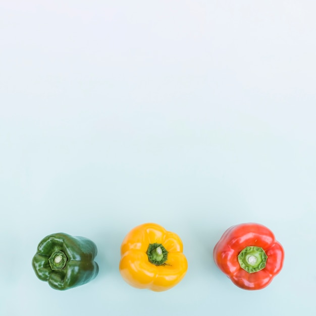 Three colorful bell peppers from above