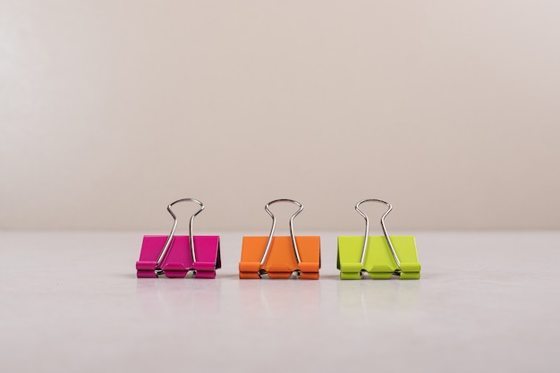 Three colorful paper clips on white background