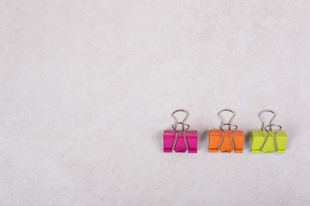 Three colorful paper clips on white background