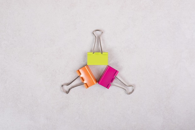 Three colorful paper clips on white background