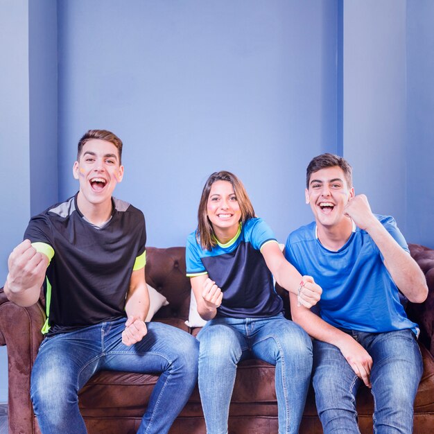 Three football fans celebrating