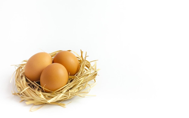 Three fresh eggs isolated on white background with copy space