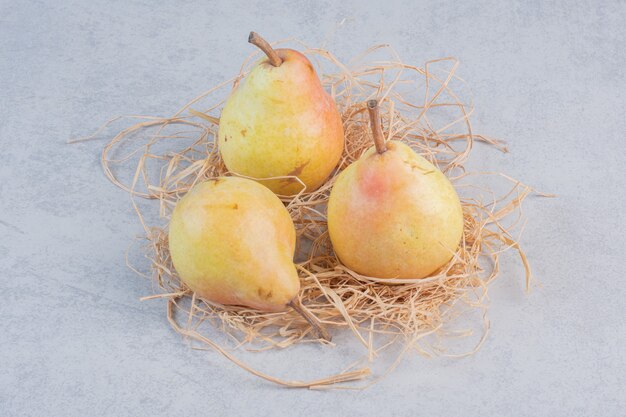 Three fresh Yellow pear on grey background. 