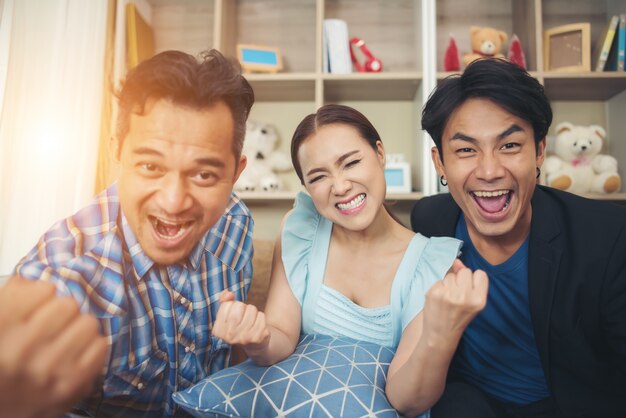 Three friend The are big glad after watching TV