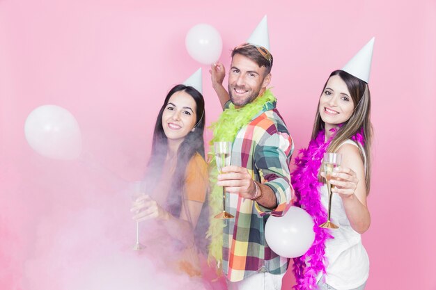 Three friends enjoying the champagne flute in the party