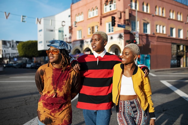 Three friends posing outside in the city