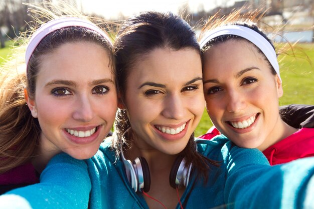 three friends taking photos with a smartphone