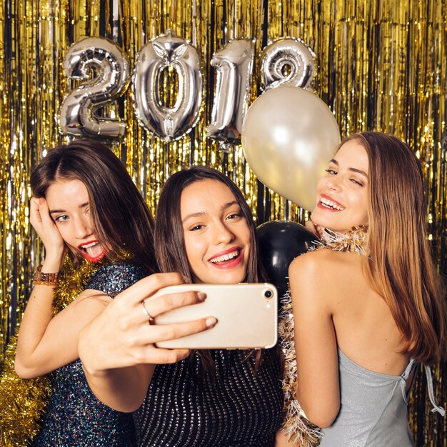 Three friends taking selfie on new year celebration