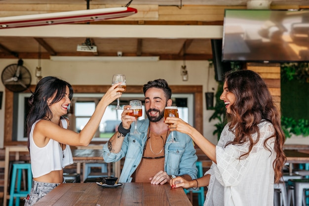 Three friends toasting with beer