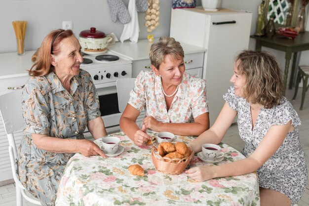 Three generation women talking something during breakfast