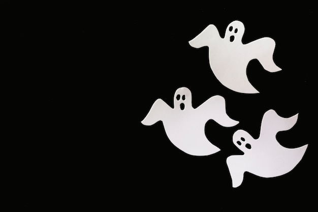 Three ghosts made of white paper