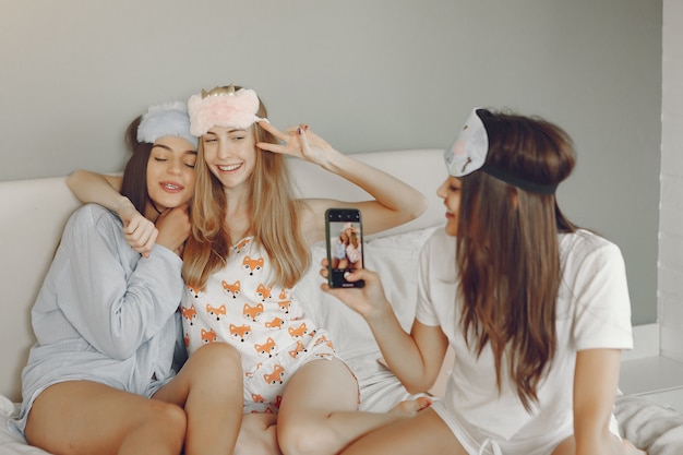 Three girls have a pajamas party at home
