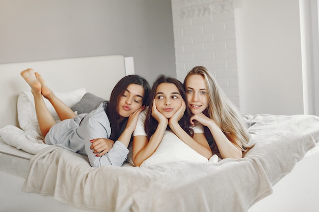 Three girls have pajamas party at home