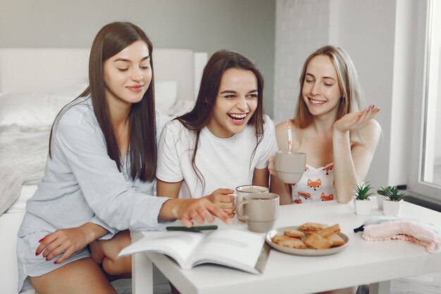 Three girls have pajamas party at home