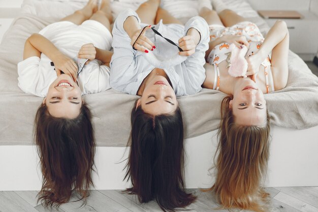 Three girls have pajamas party at home