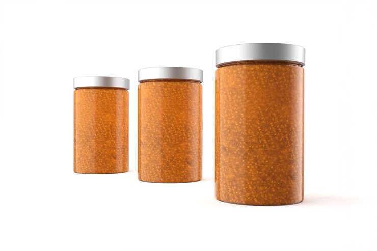 Free Photo three glass jars with orange contents and metal lids