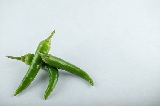 Three hit chili peppers on white background. 