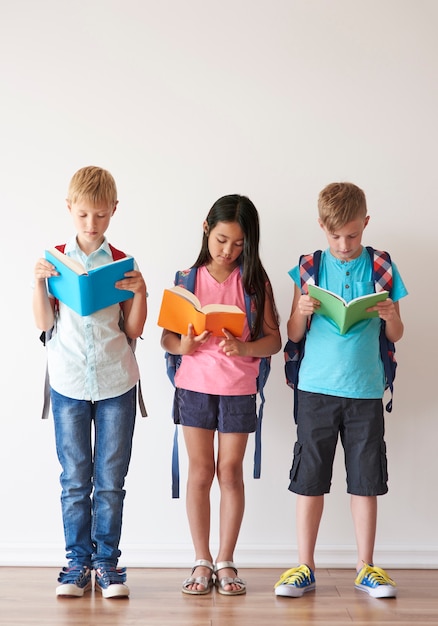 Three kids double checking homework