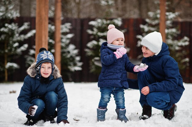 Three kids playing in winter day Brothers with yongest sister