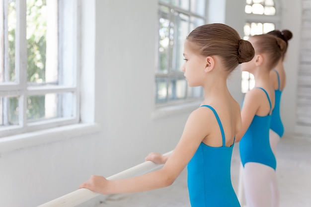 Three little ballet girls posing together