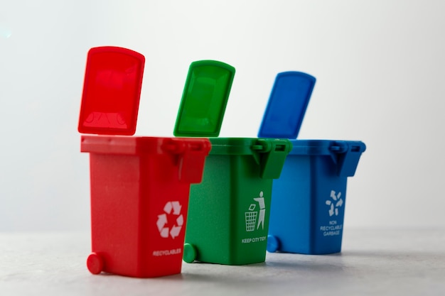 Free photo three miniature recycle bins