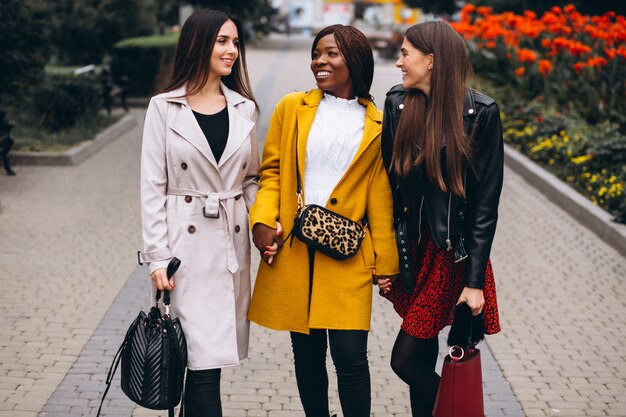 Three multicultural women after shopping