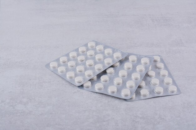 Three packs of medical drugs on marble surface. High quality photo