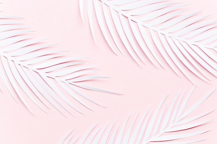 Free Photo three paper palm leaves on pink table