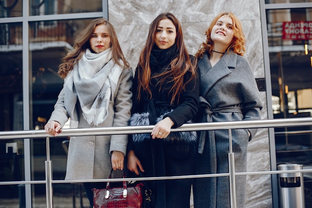 three pretty girl in a winter city
