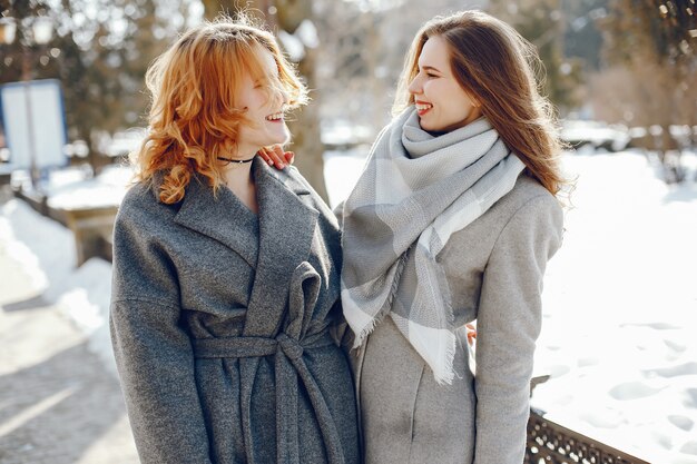 three pretty girl in a winter city