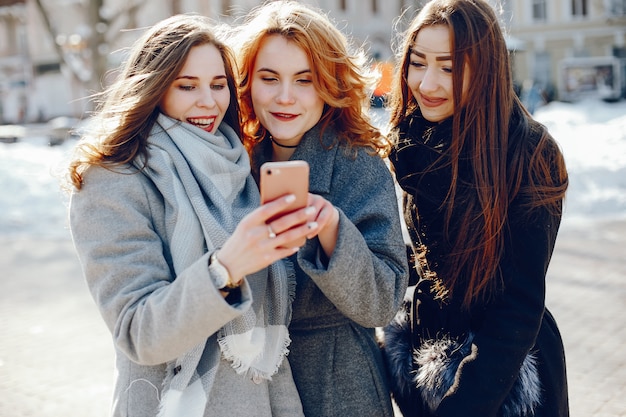 three pretty girl in a winter city