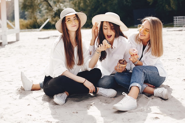 Three pretty girls in a summer park  