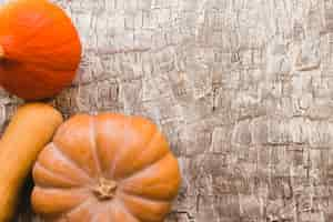 Free photo three pumpkins on table