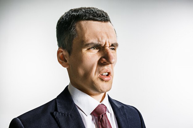 Three-quarter portrait of a businessman with disgust face.