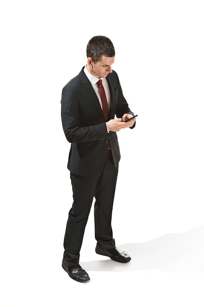 Three-quarter portrait of a businessman with very serious face. Confident professional with piercing look in the foreground of the camera.